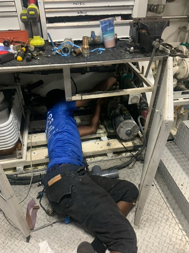 Reefco Services tecnician working in tight space